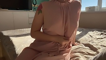 A Woman In A Pink Dress Explores Her Sensuality By Indulging In Self-Pleasure